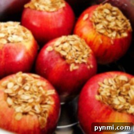 Six pressure cooker baked apples stuffed with oats and cinnamon in a pot.