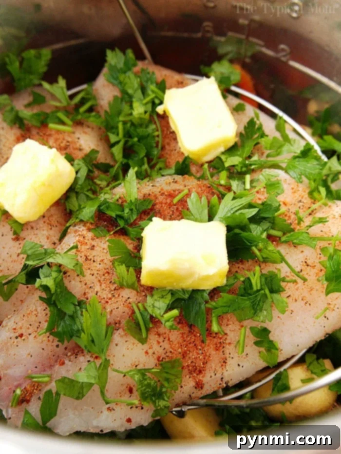A pressure cooker with freshly cooked tilapia and vibrant vegetables ready to be served.