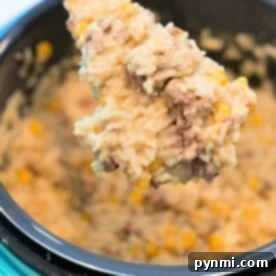 Spoonful of creamy rice, ground beef, and corn from an instant pot hamburger casserole.