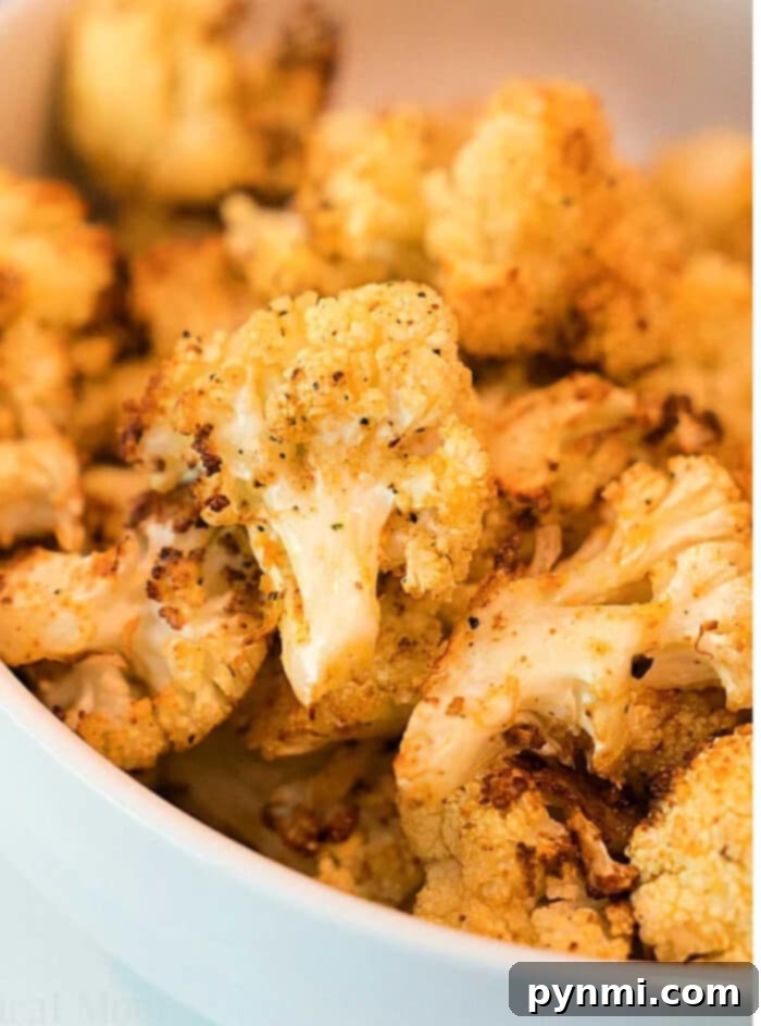 Crispy 2 Crispy golden-brown air fryer cauliflower florets arranged on a plate, ready to serve.