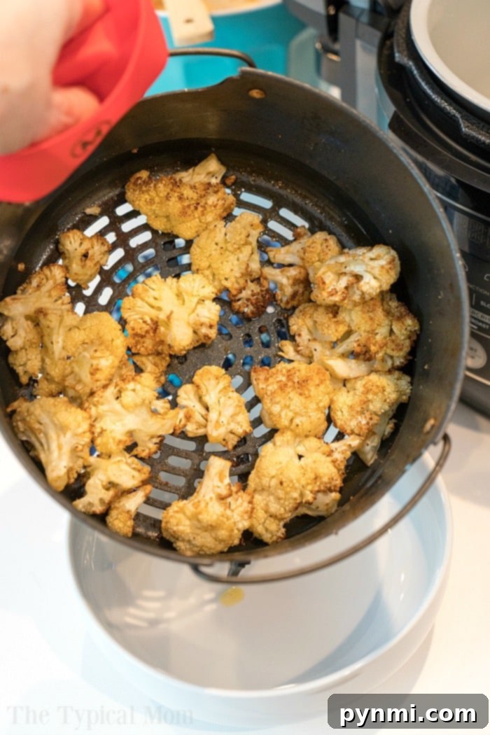 How to make cauliflower in air fryer. #airfryer A perfectly cooked batch of air fryer cauliflower, showcasing its appetizing roasted appearance.