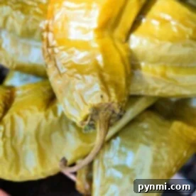 Close-up of roasted hatch chiles stacked together, perfect for spicing up your favorite hatch chile recipes.