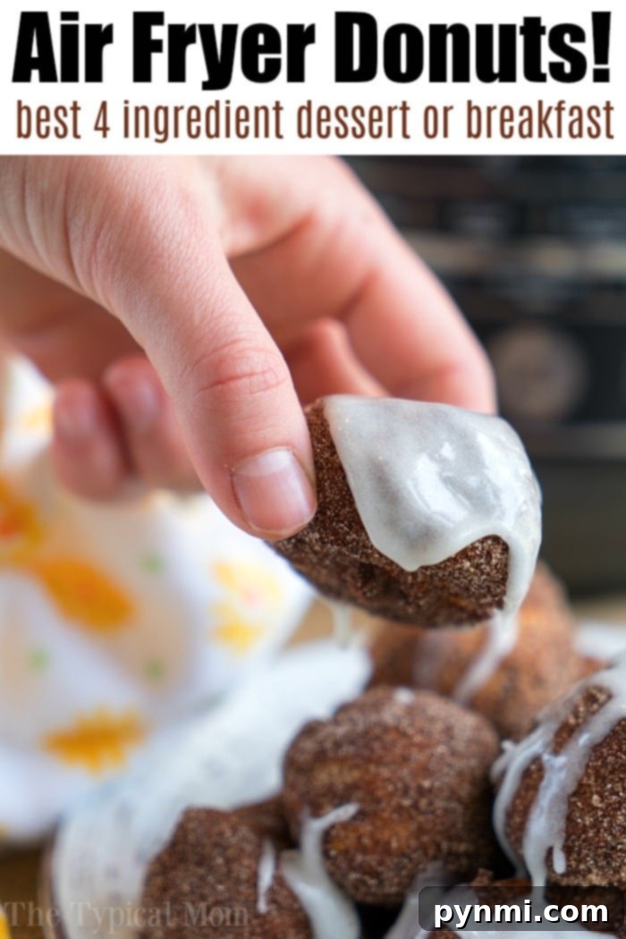 A hand holds a glazed donut over a stack of similar delights, promoting air fryer donuts.