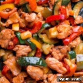 Delight in this air fryer fajitas featuring juicy chicken strips, vibrant red and yellow bell peppers, and crisp zucchini slices for a quick fajitas twist.