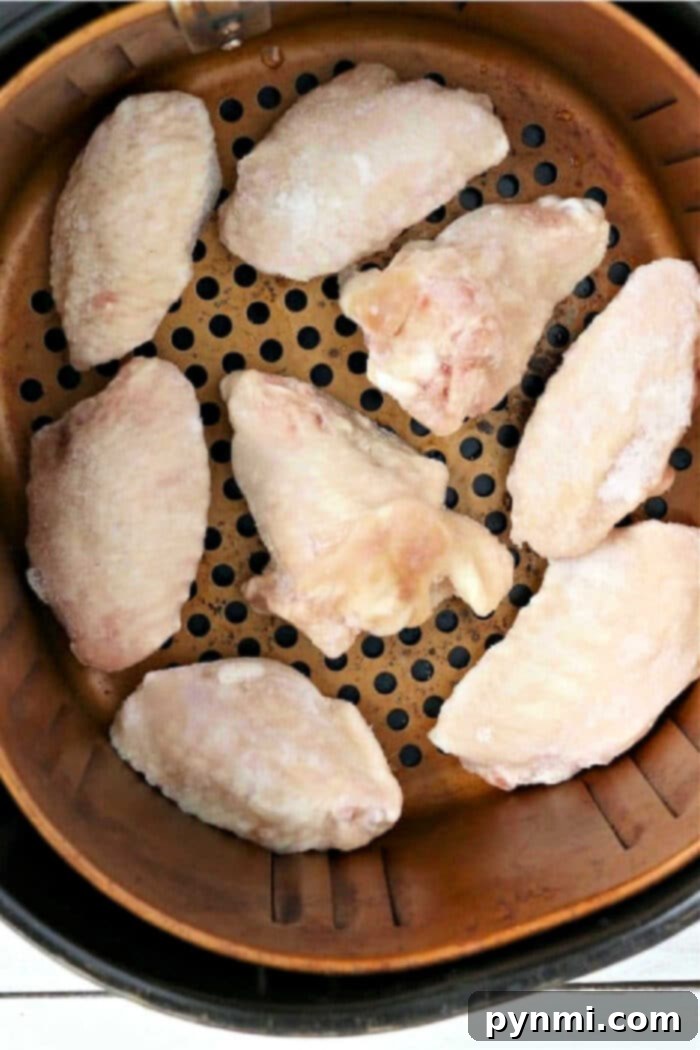 Crispy Air Fryer Frozen Chicken Wings 2 Frozen Chicken Wings in Air Fryer, arranged for optimal crisping.