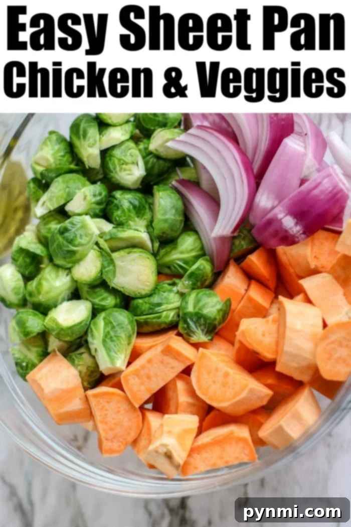 Best sheet pan chicken thighs and vegetables are so easy to throw together, bake, and enjoy with your family. A healthy meal with tons of flavor for the win. #chickenthighs #chickenrecipes #sheetpanrecipes #sheetpanchicken Close-up of golden sheet pan chicken and veggies, featuring roasted chicken thighs, sweet potatoes, and brussels sprouts.