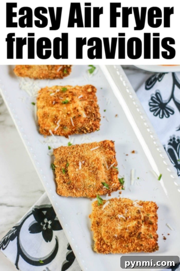 Fried ravioli in your air fryer is easier to make than you think! Using fresh or frozen cheese or meat ravioli you can get that crispy outside with NO oil like this. #airfryerrecipes #airfryer #ravioli #friedravioli #healthy #ninjafoodi A vibrant display of crispy air fryer fried ravioli with a side of rich marinara for dipping, perfect for sharing