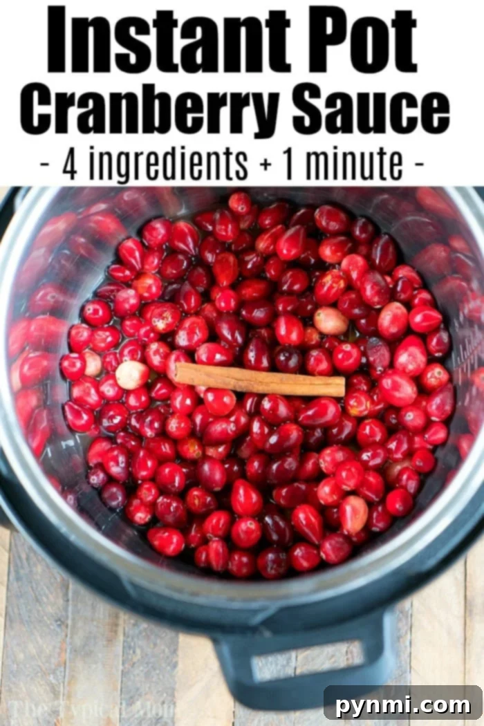 A vibrant bowl of homemade Instant Pot cranberry sauce, garnished with fresh cranberries and rosemary sprigs, ready for the holiday table.