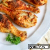 Crispy Buttermilk Chicken Legs in Your Air Fryer 7 Golden brown chicken drumsticks cooked in an air fryer.