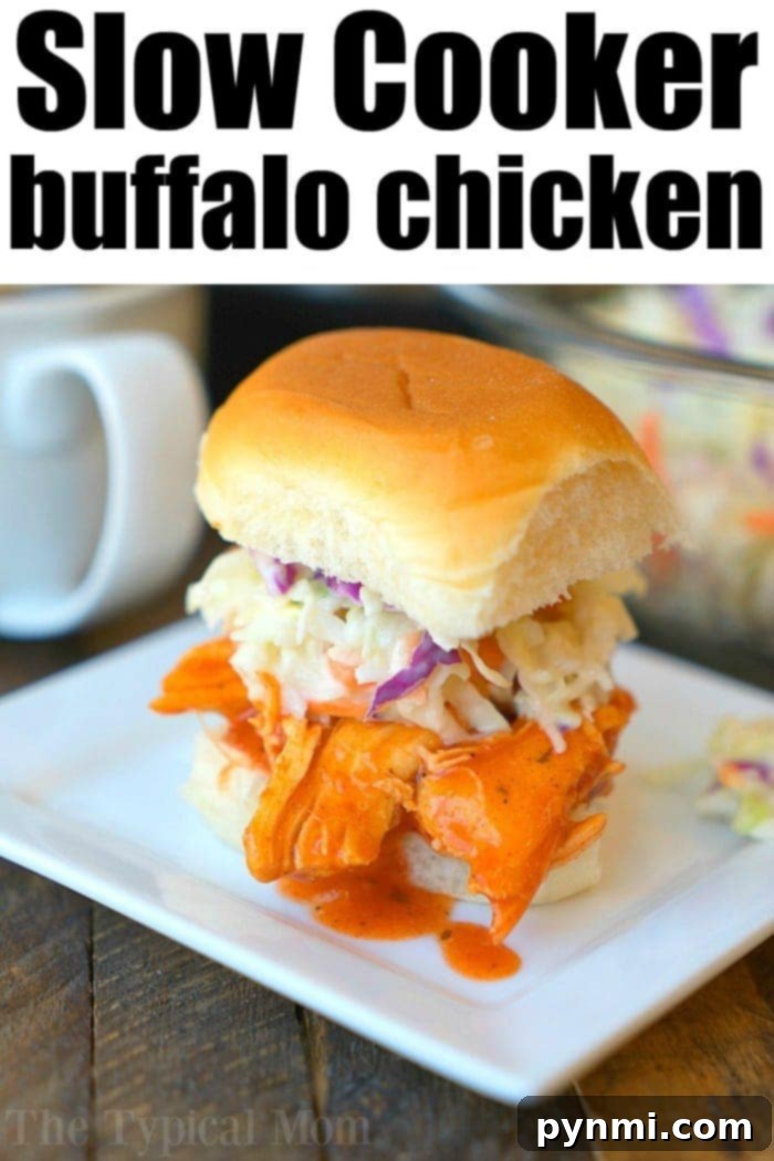 Crockpot buffalo chicken sliders! Make low carb wrapped in lettuce or on small buns as an appetizer or tasty main dinner. Slow Cookers rock. #crockpot #crockpotrecipes #crockpotchickenrecipes #buffalochicken #lettucewraps #spicychicken #slowcookerchicken #buffalochickensliders A large platter filled with Crockpot buffalo chicken ready to be served, showcasing its vibrant orange color and tender texture.