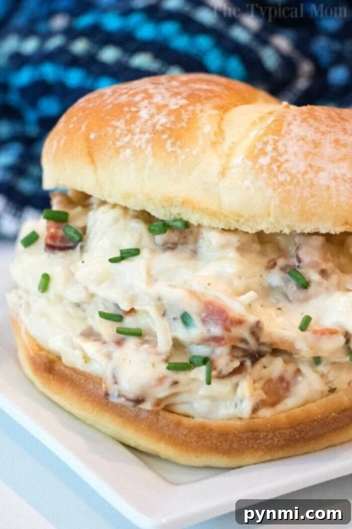 Delicious Crockpot Chicken Recipes for Your Family Savor the best crockpot chicken recipe with our creamy chicken and bacon sandwich, topped with freshly chopped chives on a soft bun.