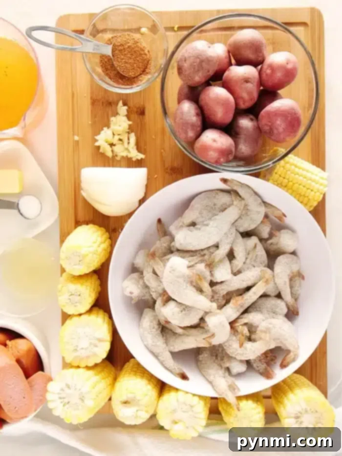 Pressure cooker shrimp boil is an easy and healthy dinner you can throw together in no time. If you love seafood and your pressure cooker you've gotta try this. A pressure cooker filled with Instant Pot shrimp boil ingredients, including corn, potatoes, and sausage, ready for the shrimp to be added.