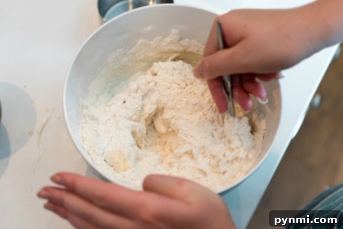 A close-up of buttery pecan snowball cookies on a cooling rack, ready for a dusting of powdered sugar.