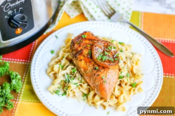 Lemon pepper chicken with creamy sauce and fresh parsley on a plate.