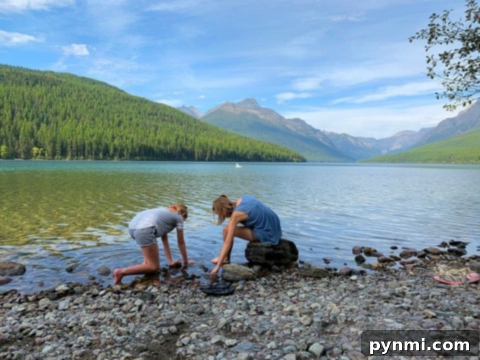 Bowman Lake in Glacier National Park, showing clear waters and surrounding forest
