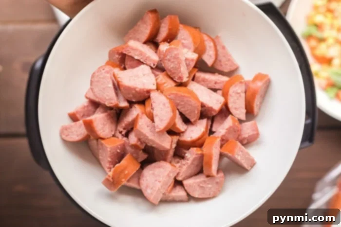 Creamy Cheesy Instant Pot Sausage and Rice 3 Close-up of pressure cooker sausage and rice, showcasing the texture and rich colors of the ingredients.