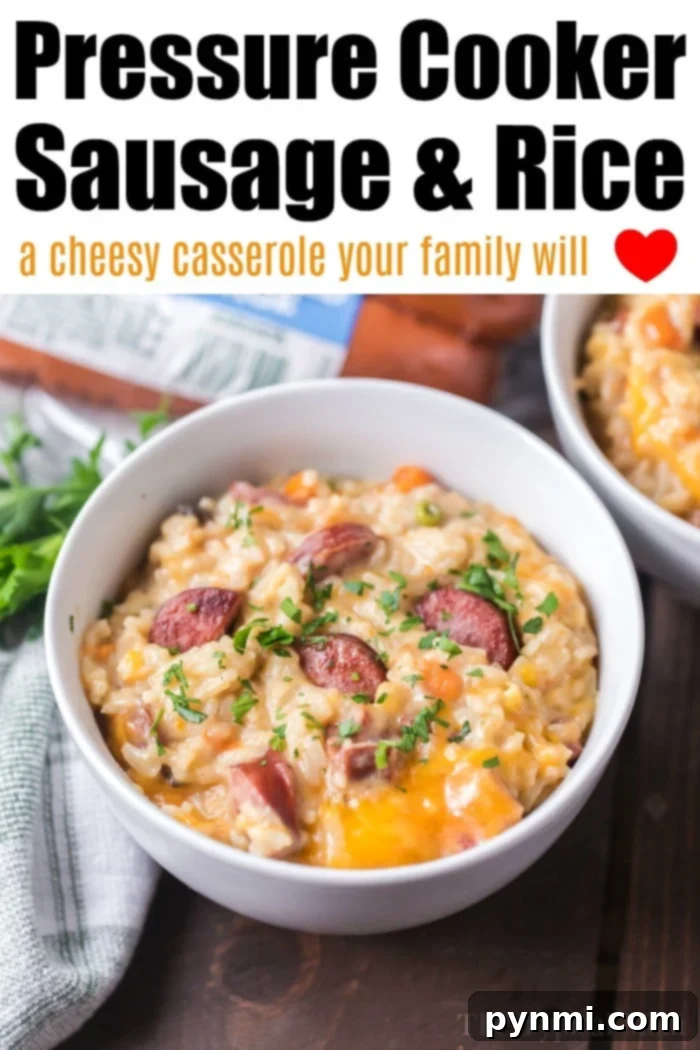 Instant Pot sausage and rice is so good! A cheesy casserole packed with smoked sausage, tender rice and vegetables cooked all in one pot in no time at all. #instantpot #instantpotrecipes #sausage #rice #casserole #cheesy #pressurecooker #ninjafoodi A close-up shot of the Instant Pot sausage and rice casserole, highlighting the tender grains and browned sausage.