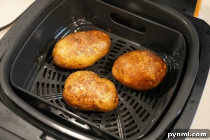 Delicious air fryer baked potatoes, golden and crispy, perfect with steak.