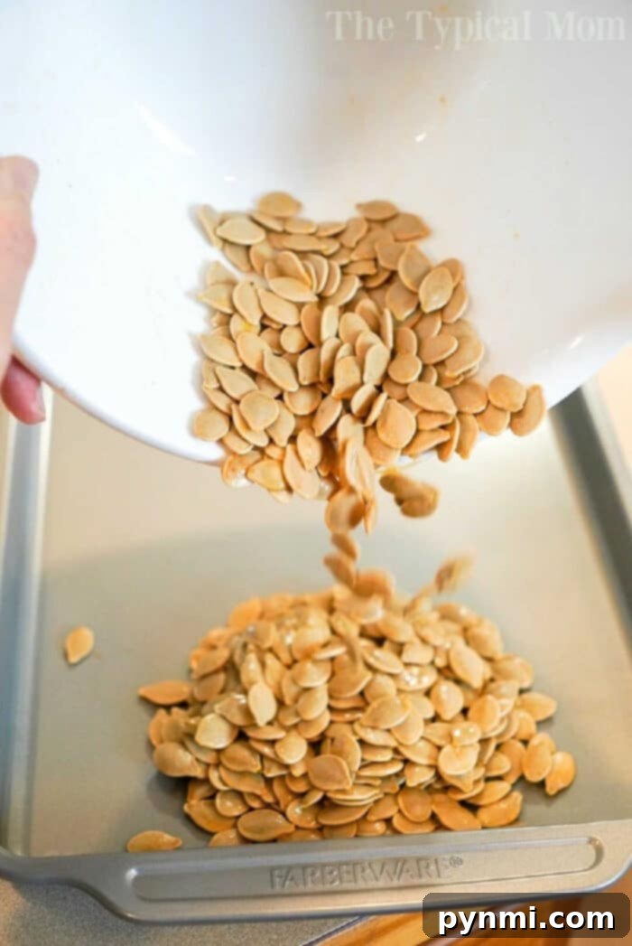 Perfectly Roasted Pumpkin Seeds 10 A close-up of a rustic wooden bowl overflowing with roasted pumpkin seeds, adorned with autumn leaves, emphasizing the seasonal delight.