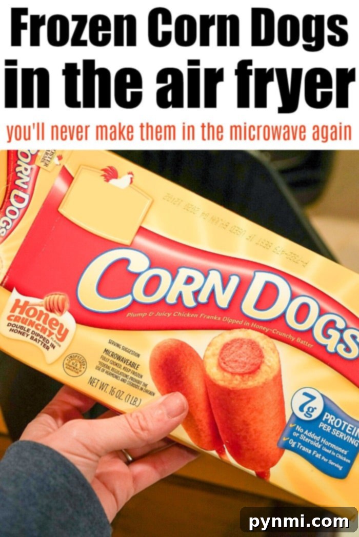 Air fryer basket filled with perfectly golden brown corn dogs, ready to be served