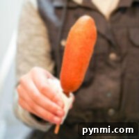 Close-up of a perfectly air-fried corn dog with a crispy golden batter