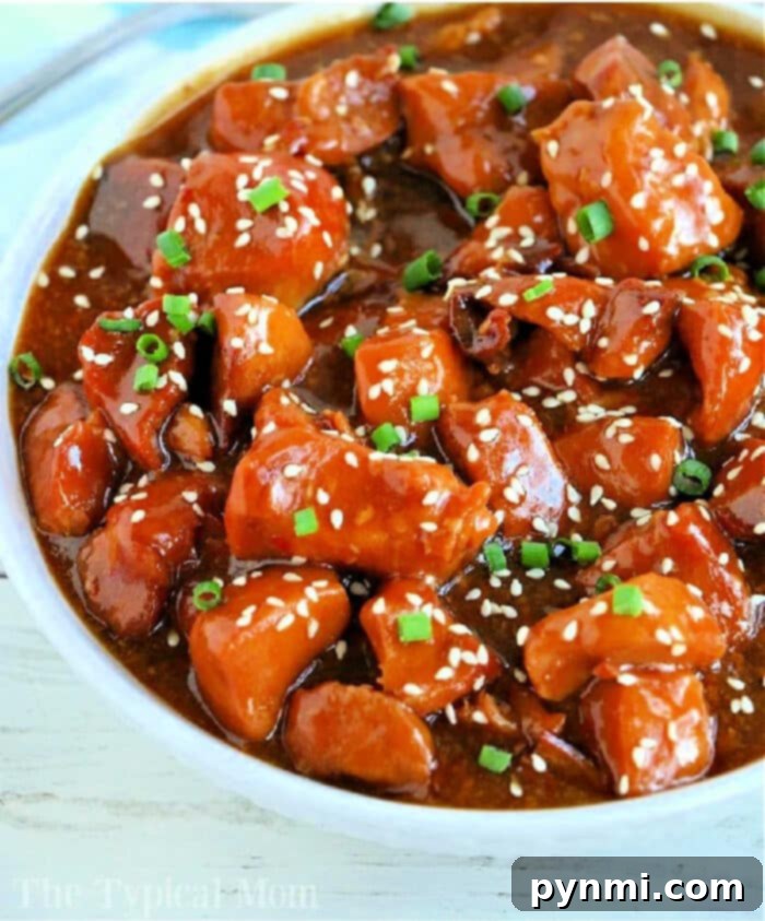 Sticky Honey Sesame Slow Cooker Chicken Thighs 2 Delicious Crockpot Sesame Chicken served over rice, garnished with sesame seeds.