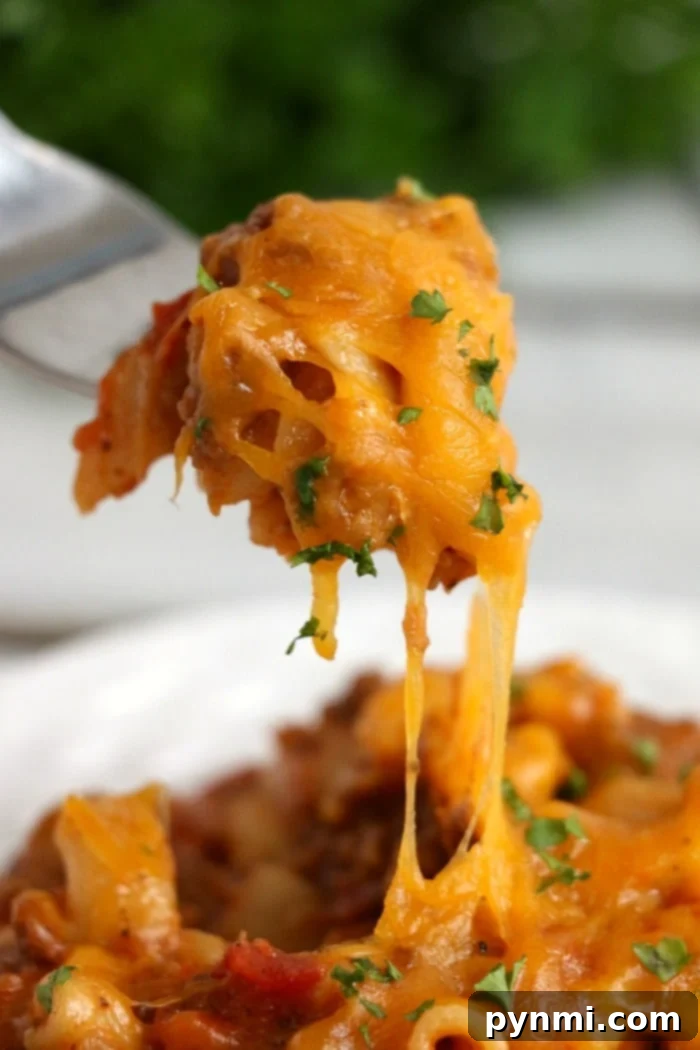 A generously sized slow cooker filled with ready-to-serve crockpot chili mac, inviting and delicious.