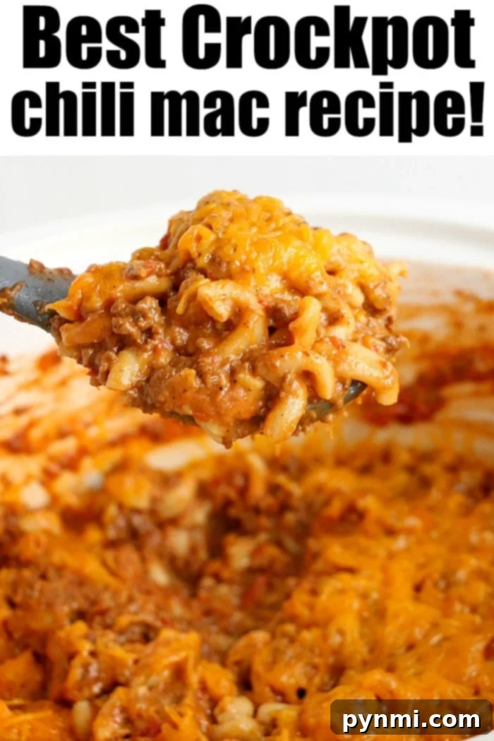 A close-up shot of uncooked elbow macaroni being added to a rich, simmering pot of crockpot chili mac.