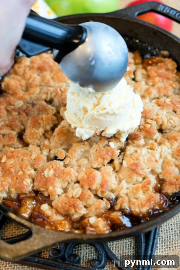 Skillet-Baked Apple Crisp with Toasted Oats 2 Scooping vanilla ice cream onto a freshly baked apple crisp in a cast iron skillet brings the delightful aroma of warm spices and fruit, much like a classic cast iron apple crisp.