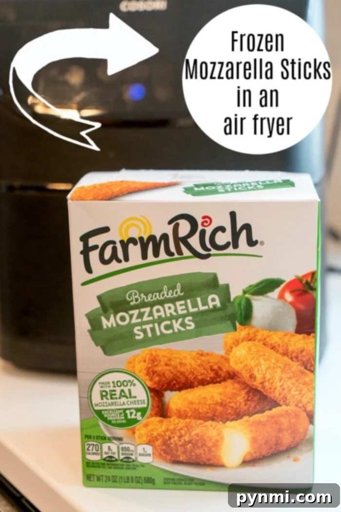 Frozen mozzarella sticks arranged neatly in an air fryer basket before cooking.