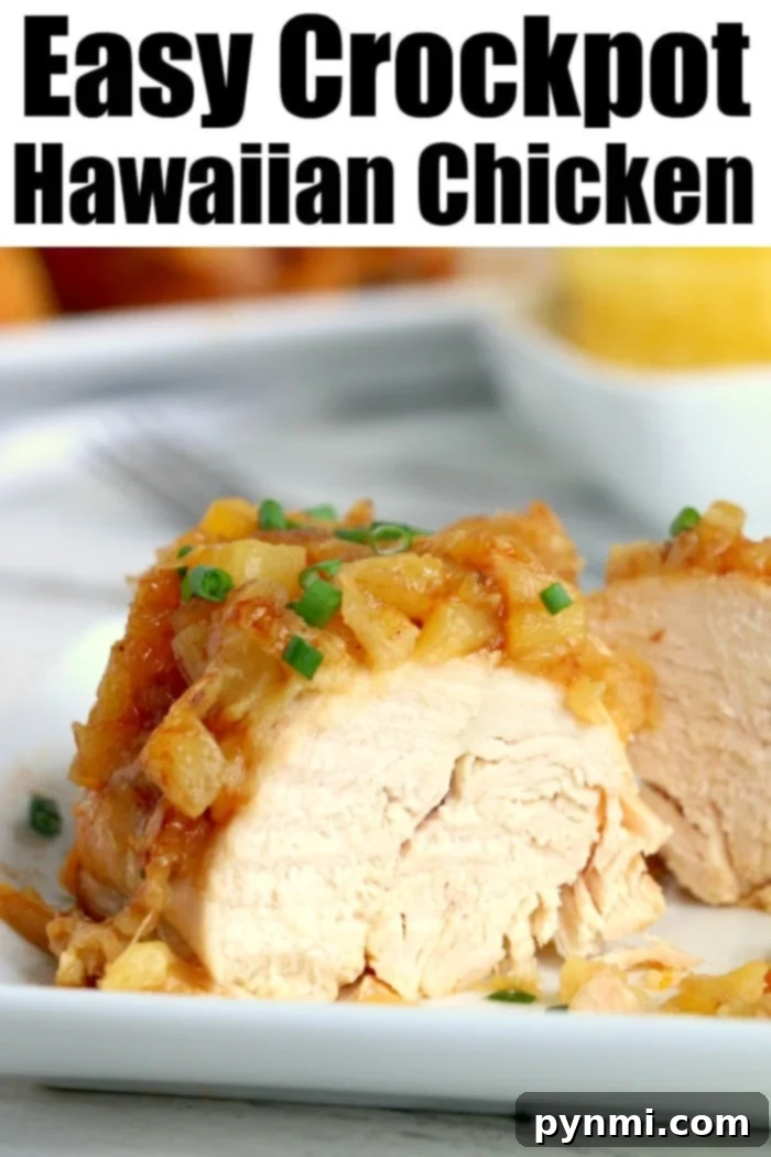 Crockpot Hawaiian chicken has only 5 ingredients! Some call this slow cooker pineapple chicken because it's sweet with a bit of a barbecue kick to it! #crockpotrecipeseasy #crockpotrecipes #slowcookerrecipes #hawaiianchicken #pineapplechicken A delightful close-up of a serving of Crockpot Hawaiian chicken, glistening with its sweet and savory sauce, garnished with fresh green onions and tender pineapple chunks, emphasizing its succulent texture and appealing presentation.