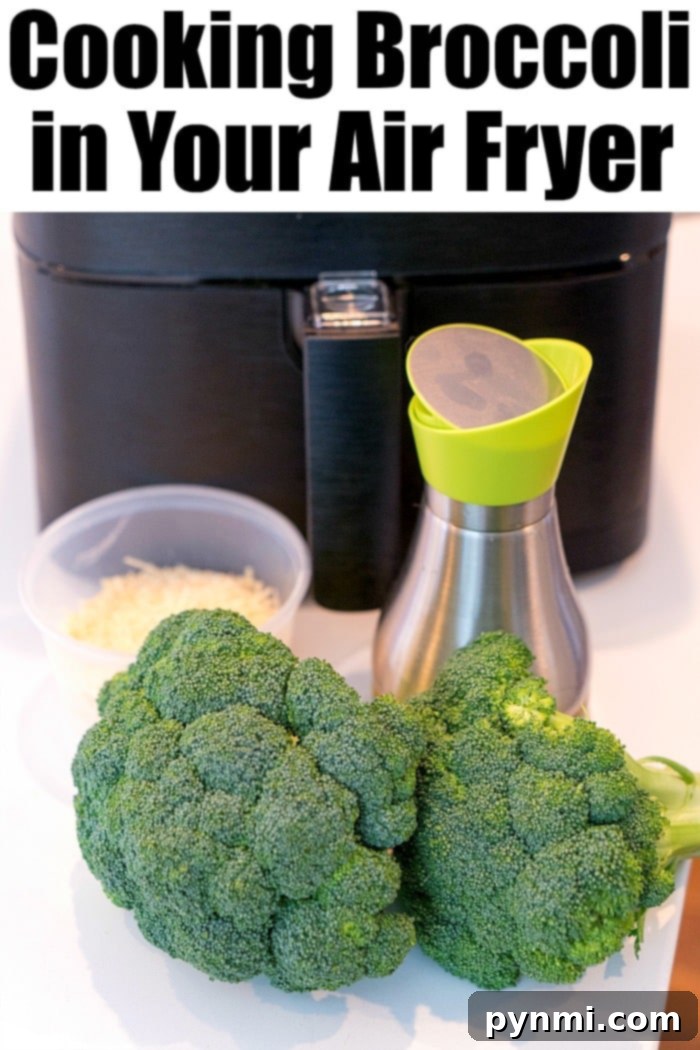 Air fryer broccoli is easy. Toss it in parmesan and olive oil for a crispy cheesy taste that's a great side dish with any meal. #airfryerrecipes #ninjafoodirecipes #foodi #foodirecipes #airfryerbroccoli #broccoli #airfryervegetables #ninjafoodibroccoli Close-up of air fryer broccoli tossed with Parmesan cheese, ready to be served