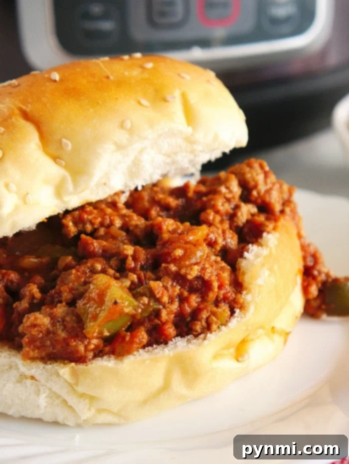 Easy Instant Pot Sloppy Joes: A Quick & Delicious Pressure Cooker Ground Beef Recipe Delicious Instant Pot Sloppy Joes in a pressure cooker pot, with steam rising.