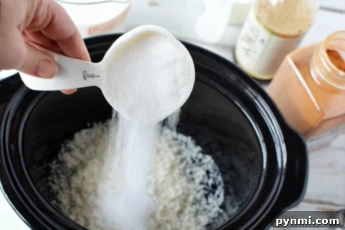 Pouring sugar into a slow cooker to create a creamy rice pudding, highlighting the process.