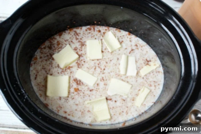 A close-up shot of a slow cooker with rice pudding gently cooking, showing its creamy texture.