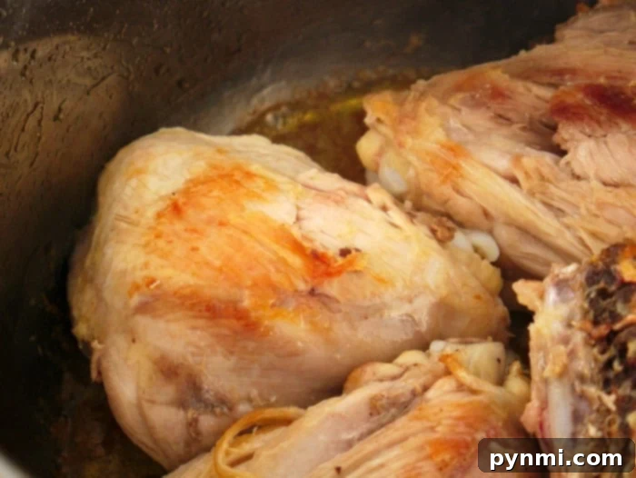 Zesty Instant Pot Lemon Chicken 4 Cooked pieces of thighs in instant pot, infused with the zesty aroma of lemon garlic chicken, creating a delightful combination.
