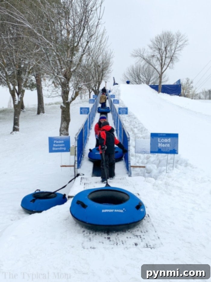 Eagle Island Tubing: Your Premier Destination for Boise Winter Fun Family sledding down a hill at Eagle Island in Boise