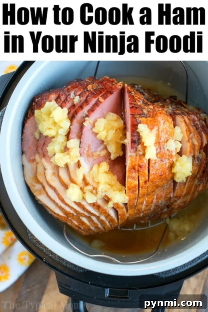 A beautifully presented Ninja Foodi ham, perfectly cooked and glazed, a holiday meal centerpiece.