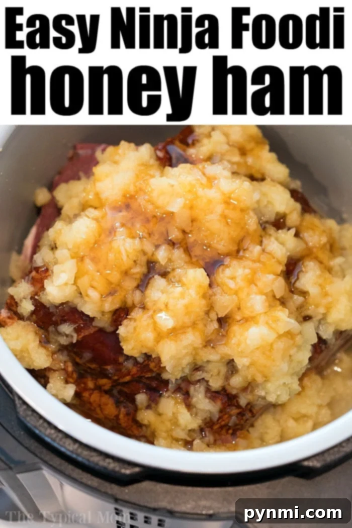 A perfectly cooked Ninja Foodi honey ham, glistening with pineapple glaze, ready to be served.