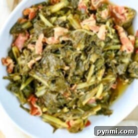 A bowl of tender collard greens mixed with savory bacon, effortlessly cooked to perfection in an Instant Pot.