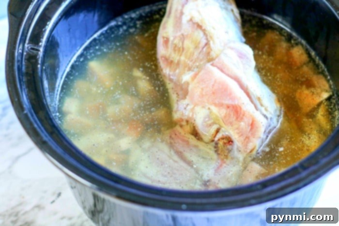 A savory ham bone resting in a pot of simmering black eyed peas.