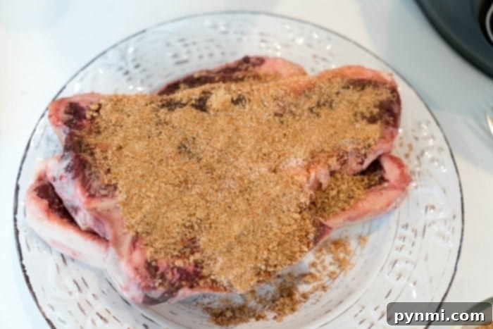 Ninja Foodi Feast: Steak and Creamy Mash 4 steak rub being applied to raw steak