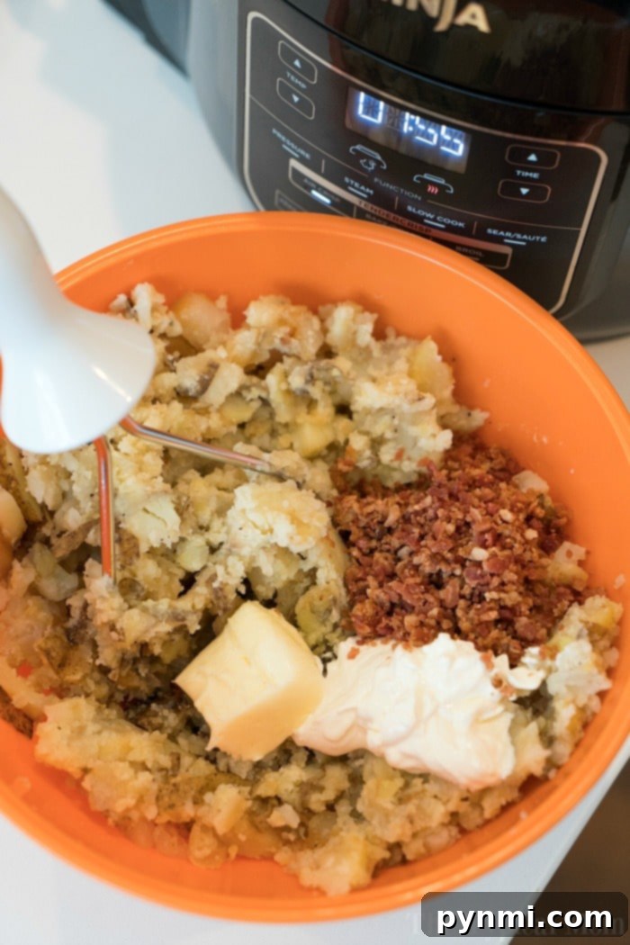 Ninja Foodi mashed potatoes comes out great, all in one pot! Tender pressure cooked meat and potatoes, then air fried steak with the best dry rub. #ninjafoodi #ninjafoodirecipes #foodi #steak #mashedpotatoes #onepotmeals #thetypicalmom pressure cooker mashed potatoes in a bowl