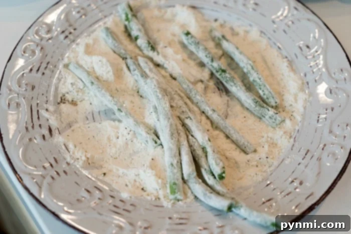 Air Fryer Crispy Green Beans 5 Air fried green beans on a baking sheet, ready for the air fryer.