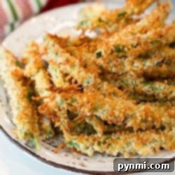A plate of golden-brown, crispy air fryer green bean fries.