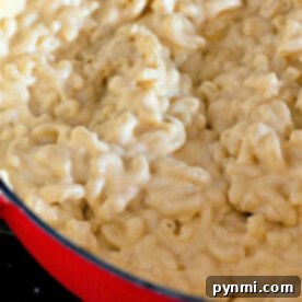 Close-up of easy homemade macaroni and cheese in a red pot, showcasing its creamy texture.