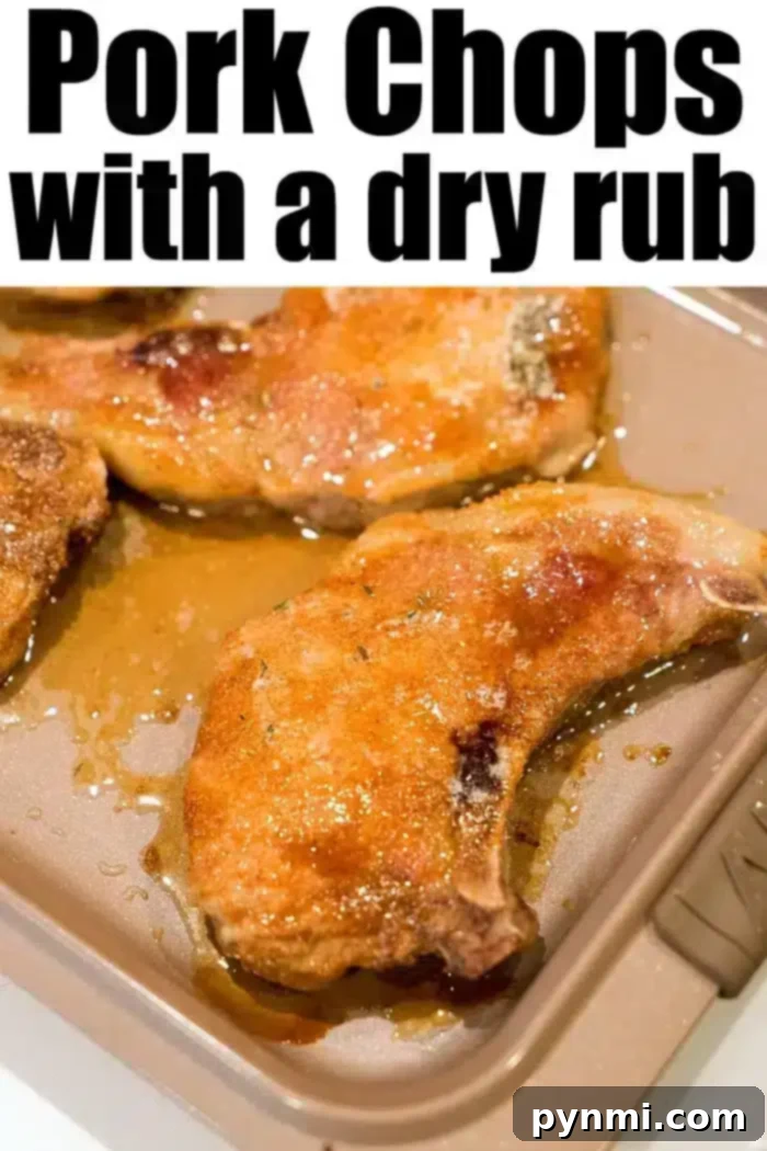The best baked pork chops are seasoned with a flavorful dry rub, arranged on a baking tray. These chops glisten with juices, showcasing their golden-brown exterior, ready to delight your taste buds.