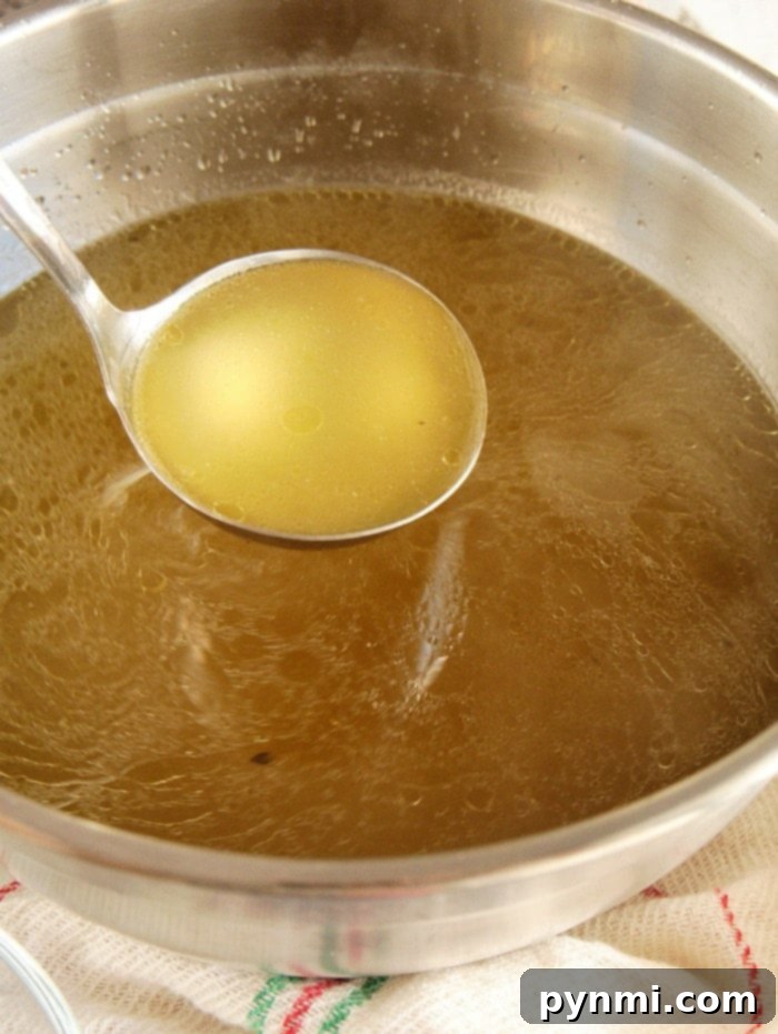 Homemade chicken broth recipe Homemade broth in a jar with herbs
