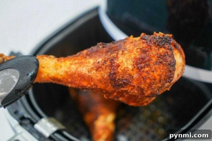 Crispy, golden-brown turkey legs, perfectly cooked in an air fryer, offering a succulent and flavorful low-carb meal option.