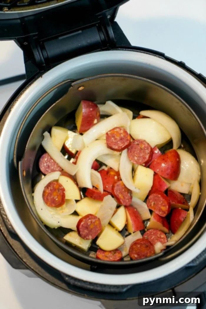 Delicious air fryer sausage and potatoes with onions
